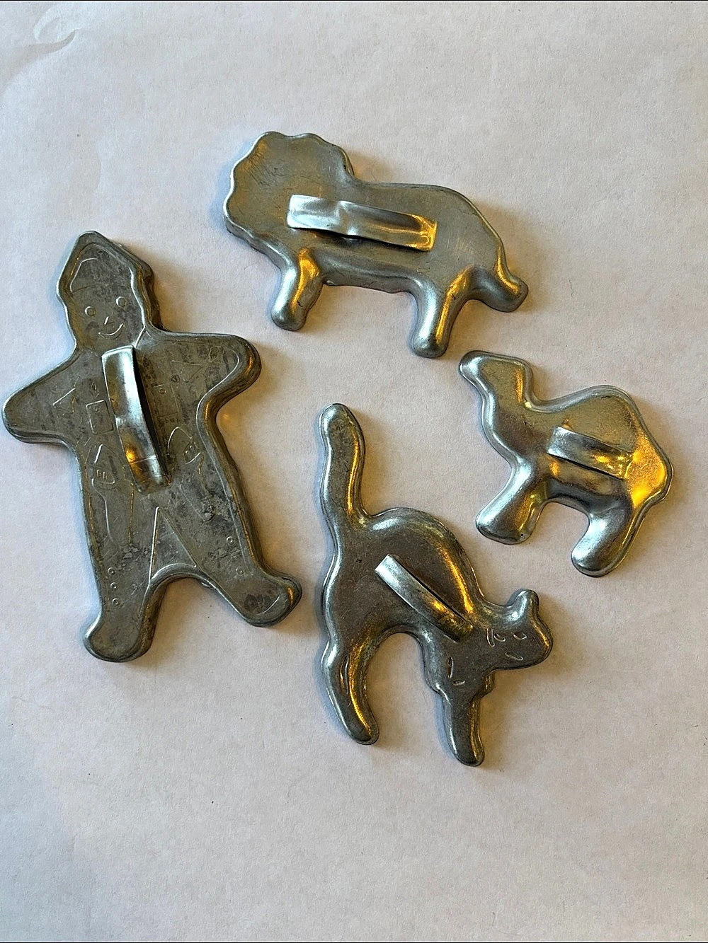 Set of 4 Vintage Aluminum Animal-and gingerbread man cookie cutters.